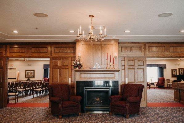 The lobby area allows people to gather outside of the visitation room and features a marble fireplace.