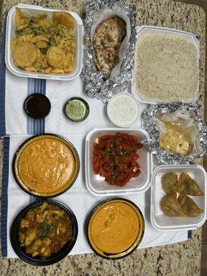 veg pakora, naan, basmati rice, Makki di Roti, Veg Samosas, Nav Ratan Korma, chicken 65, aloo gobhi, and paneer tikka masala