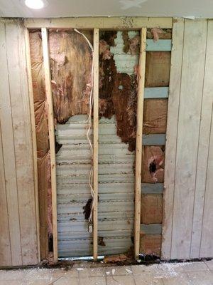 After removing the wood to find a completely rotted bottom plate,studs and wall. Covered it up with a piece of plywood ....