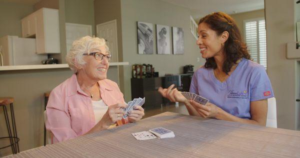 PCA playing a friendly game of cards with citizen senior.