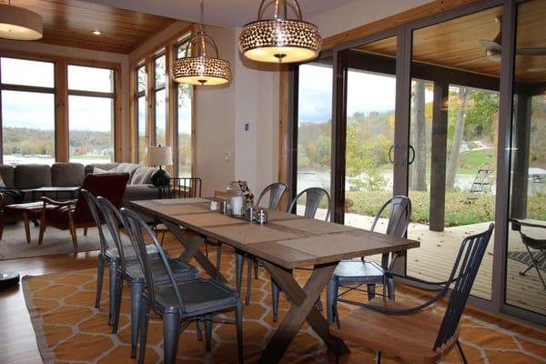 Dining area inside the River Camp getaway home. Enjoying your breakfast with these beautiful views sounds like the perfect st...