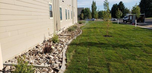 Installed sprinklers, curbing, rock ,sod, trees, bushes