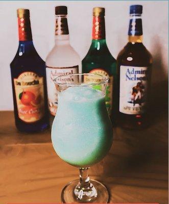 Mary Jane Our signature drink! Pina-colada flavor with a bold mix of melon liquor, spiced rum, coconut rum, and blue curacao