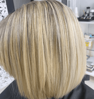 Brunette bob haircut with subtle blonde highlights for a touch of brightness.