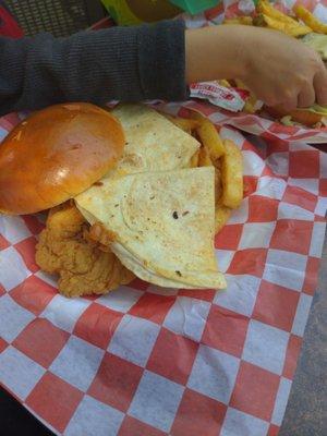 Cheese quesadilla from kid's meal on top of the chicken strips