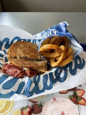 A Reuben with onion rings