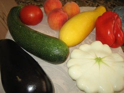 clockwise fr lower left: egg plant, zucchini, tomato, peaches, yellow squash, red bell pepper, 'flying saucer' squash