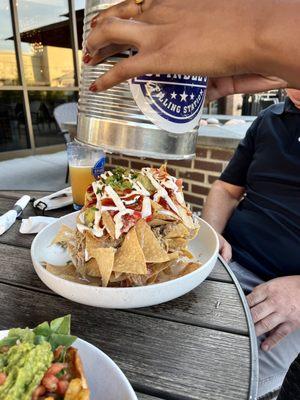 Trash can nachos being poured out