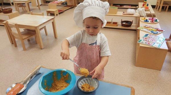 Toddler student preparing banana bread...incredible independence at 18 months!