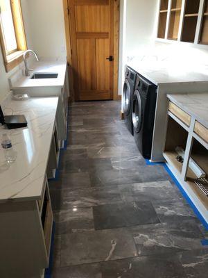 Large format floor tile in this laundry room / mud room.