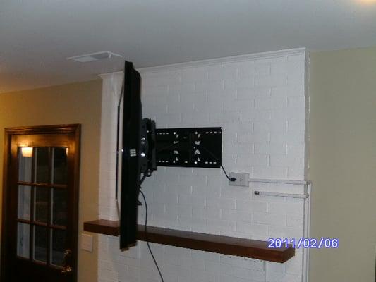 Full motion wall mount mounted against the fireplace