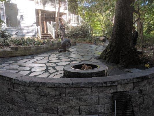 Paver patio with fire pit and wall installation