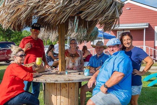 Enjoying the breeze and the palapa tables.