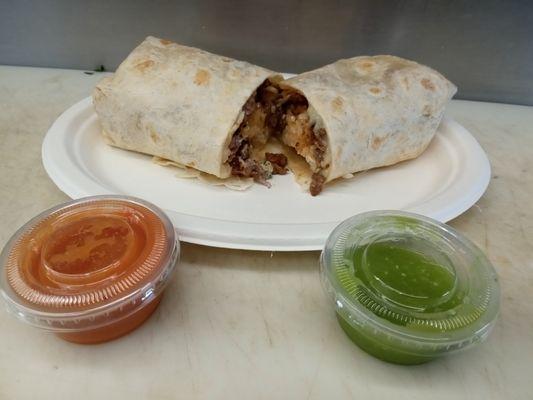 Burrito of asada ( steak burrito) comes with rice , beans, melting cheese, sour cream, onion, cilantro, and avocado and your choice of meat