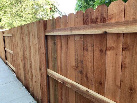 New redwood fence with steel posts