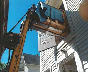 Moving a piano from the second floor of a home with our professional equipment.