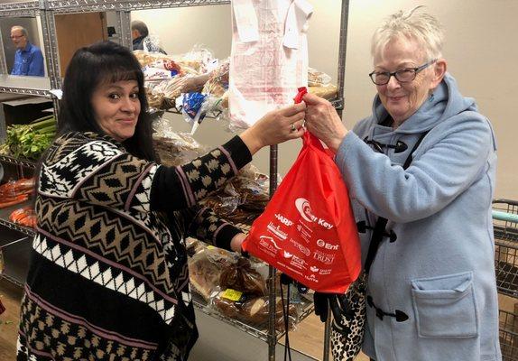 Silver Key Senior Assistance food pantry client receiving her Thanksgiving meal!