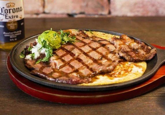 Steak & Bones Signature Steak Plate- 8oz Angus Reserve grilled Ribeye Steak on a handmade corn tortilla with a caramelized cheese crust