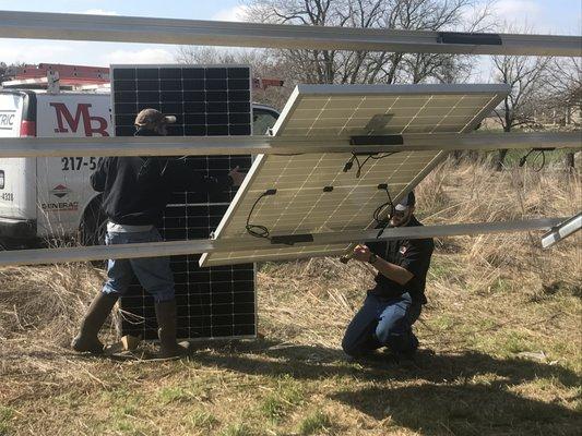 Installing a ground mount system.