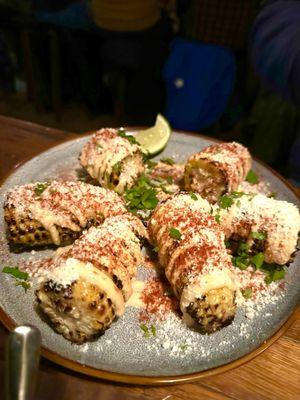 ELOTE Roasted corn on cob with lime, mayo, epazote, serrano, cotija, chili powder