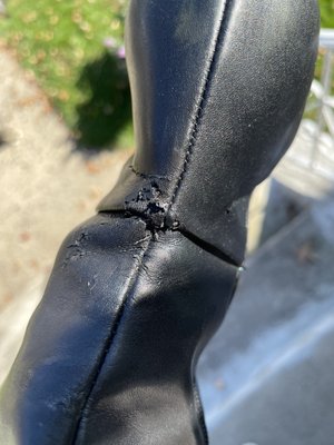 Ben's shop did this to my boots when they put the heel lifts. It appears rip was done by a machine as it's in the same spot on both boots