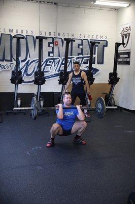 Chris nailing his set of cleans while Coach Joe looks on.