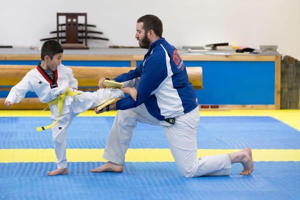 A student practices their board-breaking technique in preparation for a belt test.