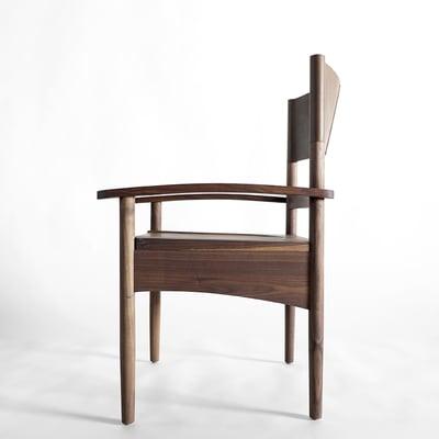 Tatanka Dining Chair with Solid Black Walnut Frame, Hand Carved Seat, and Buffalo Should Backrest.