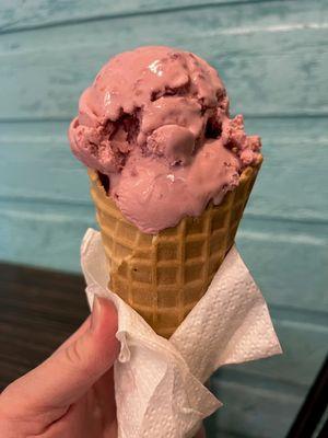 Raspberry ice cream (kids size) in a waffle cone