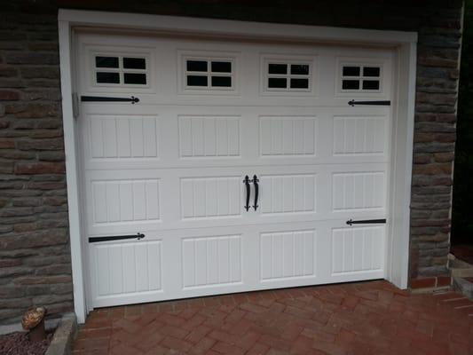 Vinyl Sonoma Door Installation, with carriage style hardware. Vinyl door is BEST when you live by the sea.