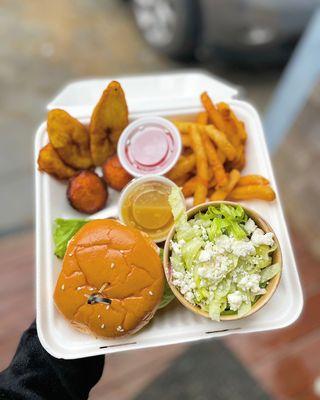 Jerk Chicken sandwich on a honey glazed bun, Greek Salad, and fries