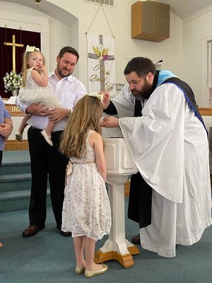 Our Pastor, Dr. John, baptizing Miss Moss.