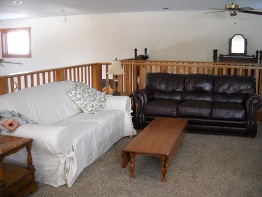 Two large sofas in the loft provide a cozy conversation area.