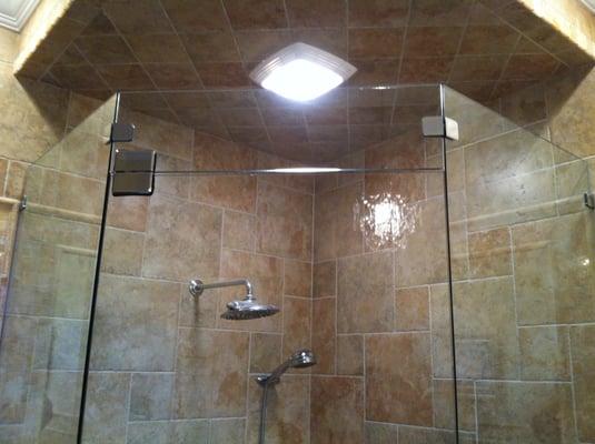 Heavy glass frameless neo-angle shower with glass header