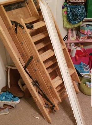 The entire attic pull down stair unit was left leaning against the wall of the child's bedroom, with facings and exposed nails sticking out.