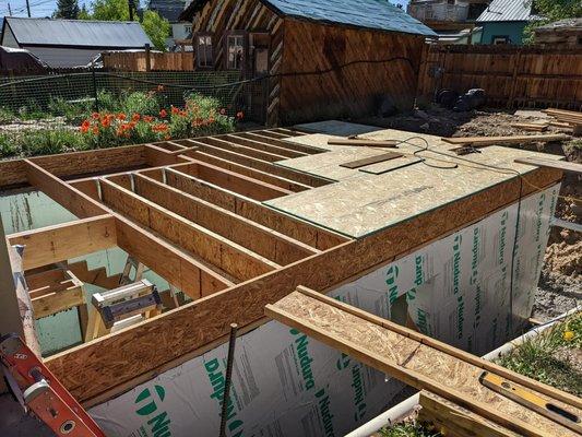 Construction of the basement. The crew was careful to keep the dogs out of the pit.