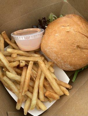 The heavenly burger with fries and a cup of fry sauce.