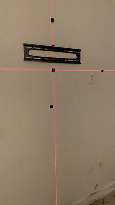 We use laser level to insure centered and leveling Tv mounts