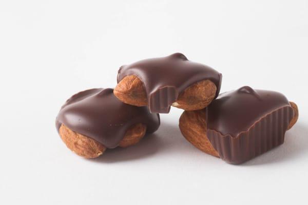 Our Dark Chocolate Almond Squares- two crisp almonds embedded in Belgian dark chocolate.