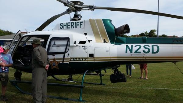 The pilot for the Sheriff Department's helicopter explaining some details to the audiance