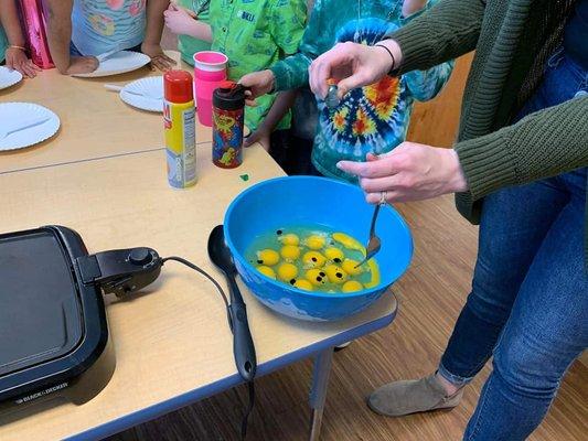 We incorporate cooking in some of our science experiments. Here they are making green eggs for Dr. Seuss.