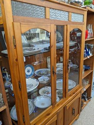 Pine and glass hutch with dishes