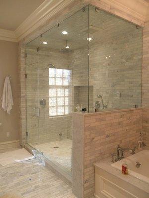 A custom frameless shower enclosure using clamps.