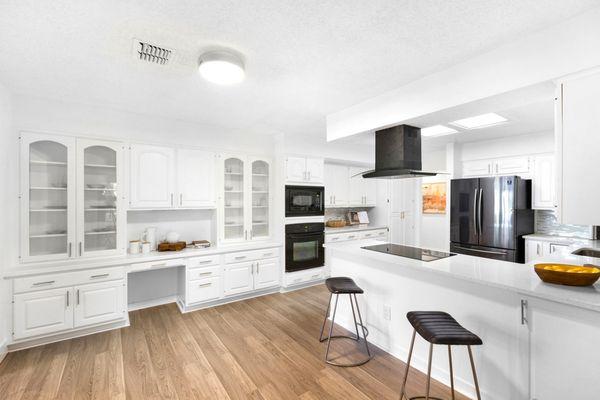 White painted cabinets and quartz counters add a modern touch to this kitchen.  FOR SALE: 4309 Monument Rd., Jacksonville, FL