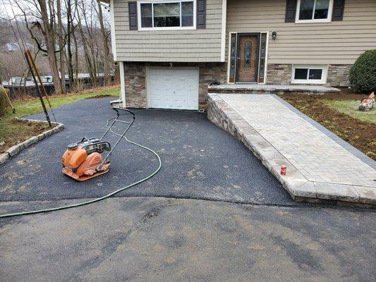 New driveway and liberty stone wall along with new paver walkway