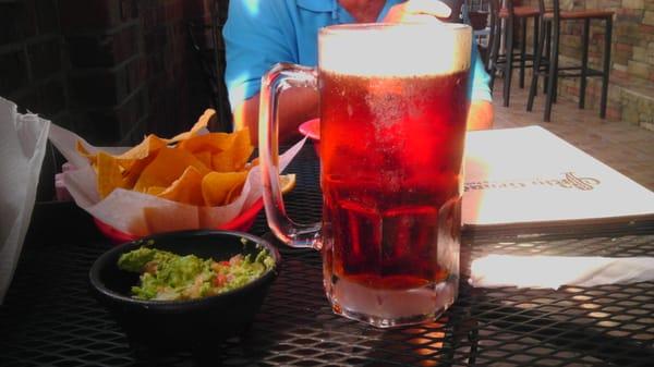 Table side fresh guacamole and a tall, cold Dos Equis amber on the patio at Rio Grande!