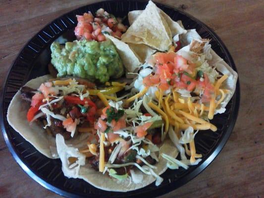 2 steak tacos, 1 chicken taco...all topped with grilled veggies with a side of pico de gallo and guacamole