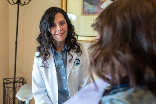 Dr. Zaibak smiling at patient at Rochester endodontics