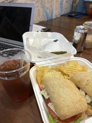 Chicken salad on panini, chips, pickle and iced tea.