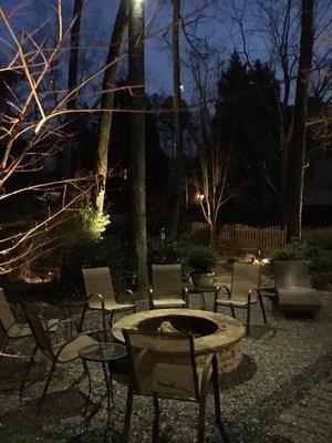 Outdoor lighting, firepit, flagstone path, slate chip/cobble edge patio by The Inspired Garden.